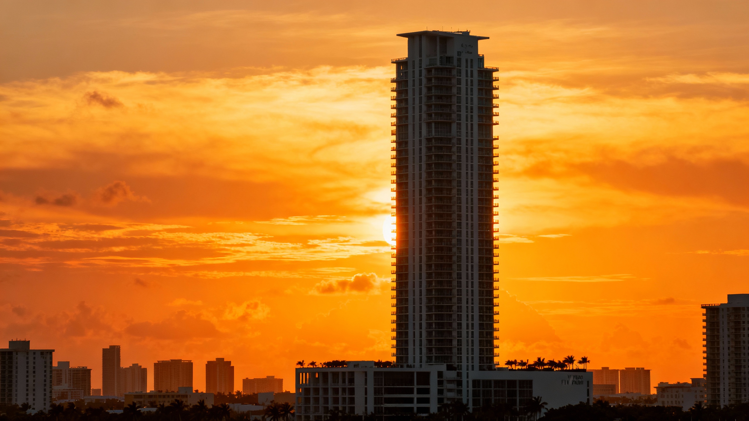 The iconic 48-story Five Park tower, the tallest in Miami Beach, against a sunset sky